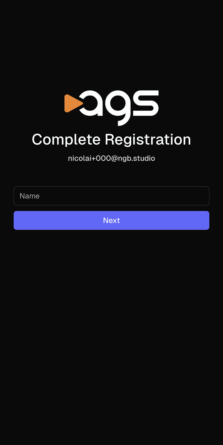 A registration screen with the ags logo (featuring an orange play button triangle next to white letters) on a black background. The page displays "Complete Registration" as a heading, with an email address "nicolai+000@ngb.studio" shown below it. There is an empty text field labeled "Name" and a purple button labeled "Next" at the bottom of the screen.